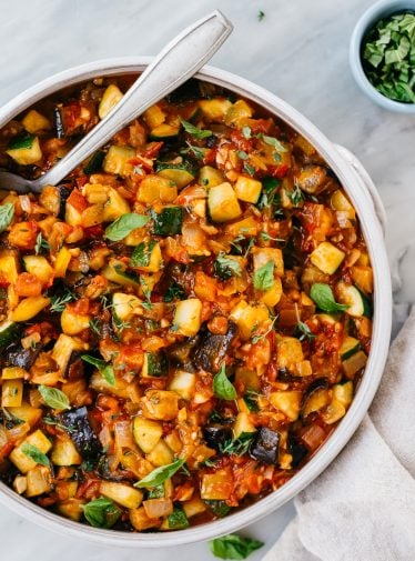 bowl of ratatouille with spoon and white linen napkin