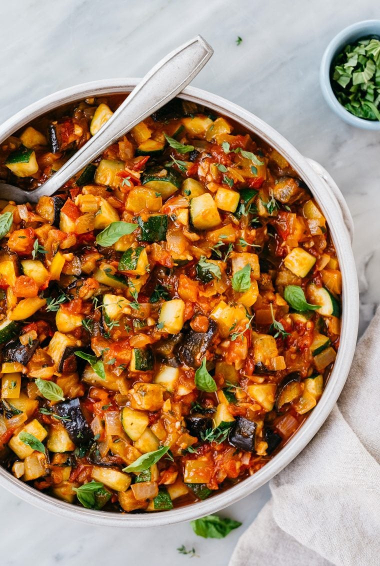 bowl of ratatouille with spoon and white linen napkin
