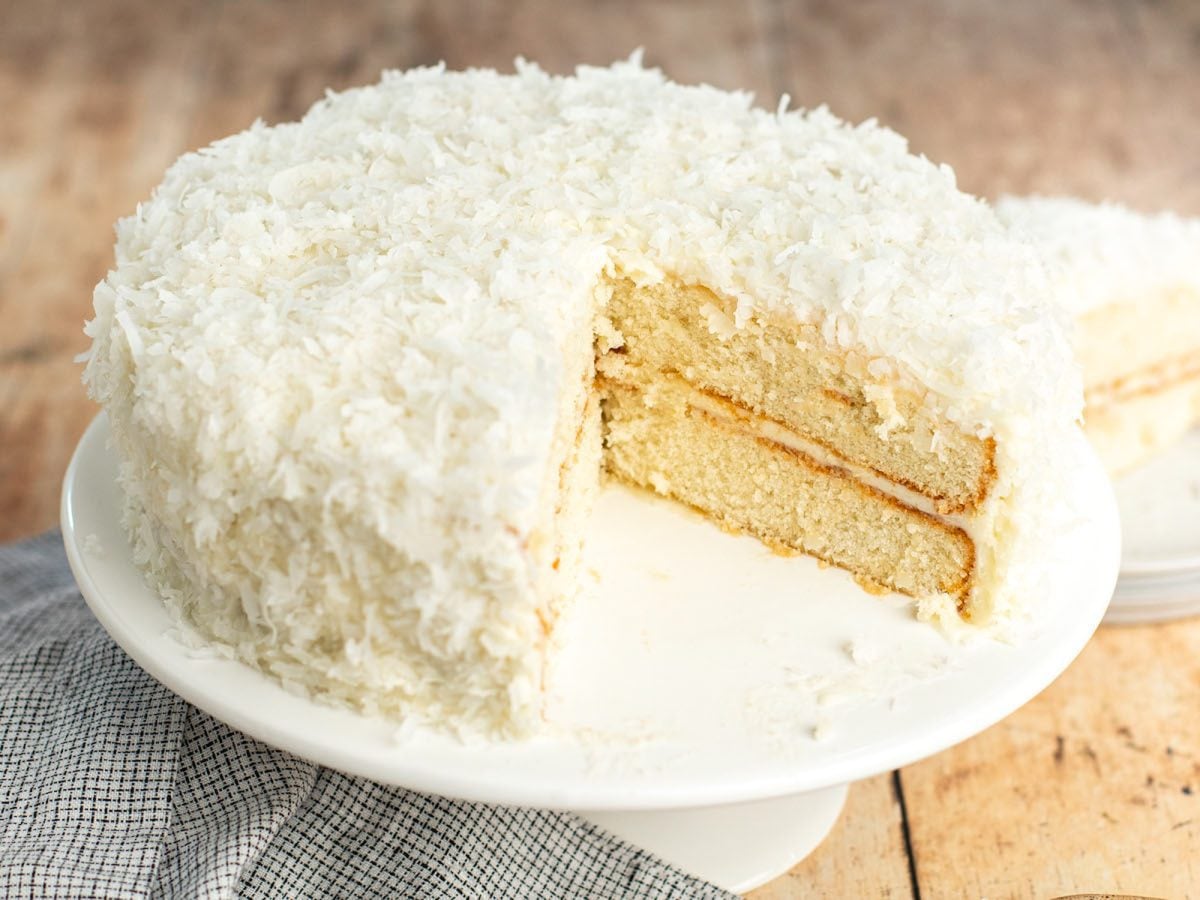 Coconut layer cake on cake stand.