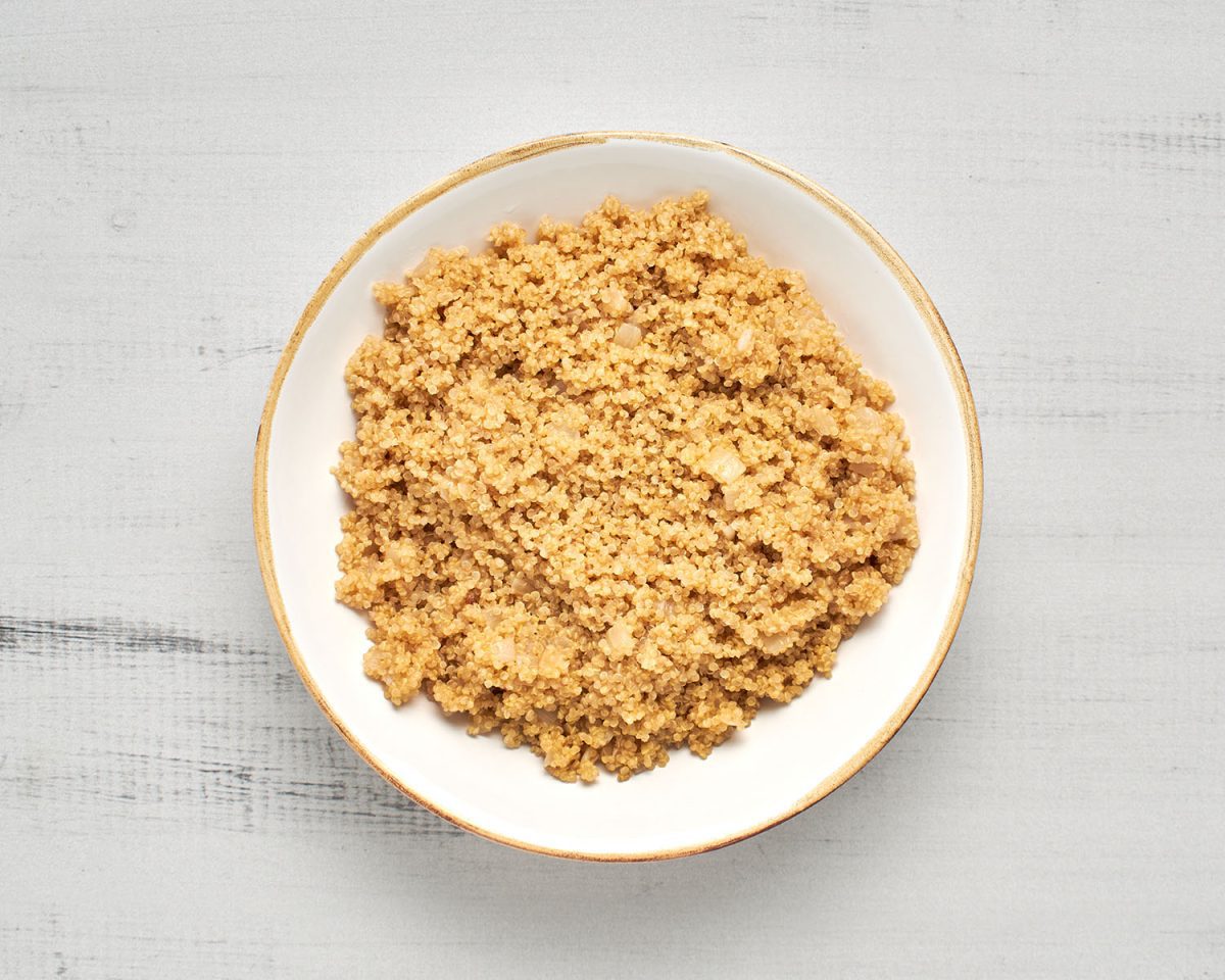 cooked quinoa and onions in white bowl
