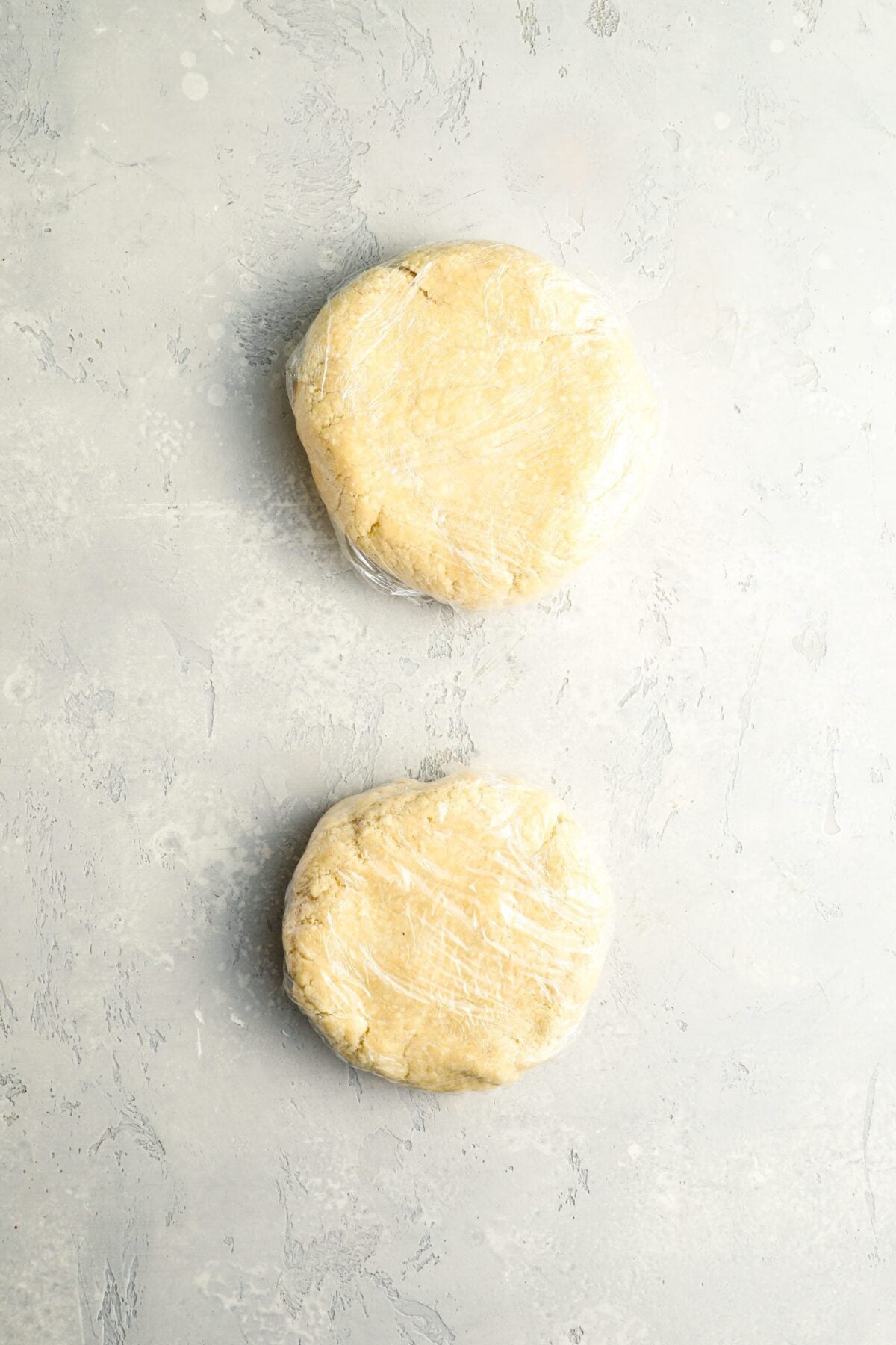 2 dough balls shaped into 5-inch discs