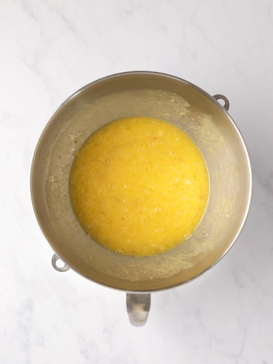 melted butter, sugar, eggs, bananas, and vanilla combined in metal mixing bowl