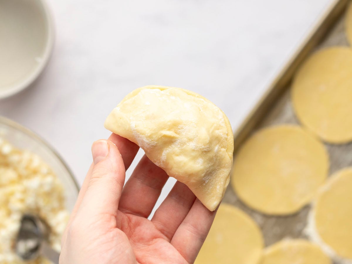 pierogi dough folded in half over filling