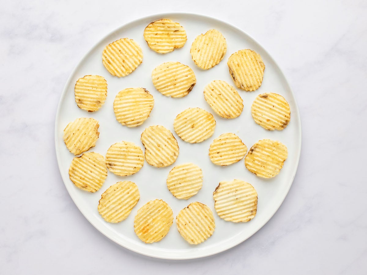 potato chips arranged on white serving platter