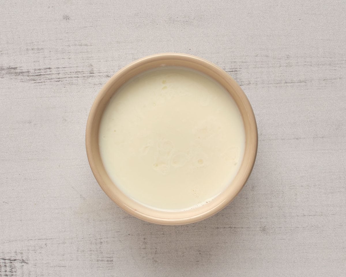milk and lemon juice in tan colored bowl
