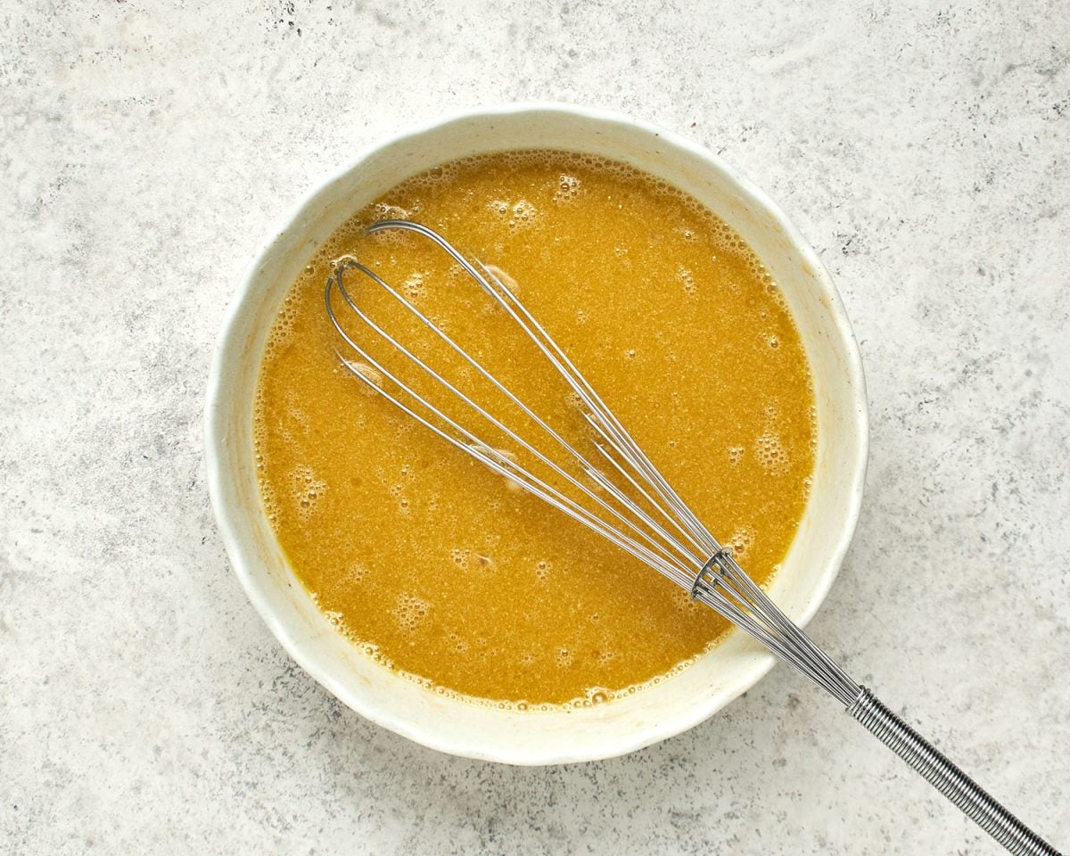  eggs, maple syrup, sugar, oil and milk whisked together in large white bowl