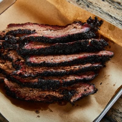 smoked brisket on parchment paper lined baking sheet