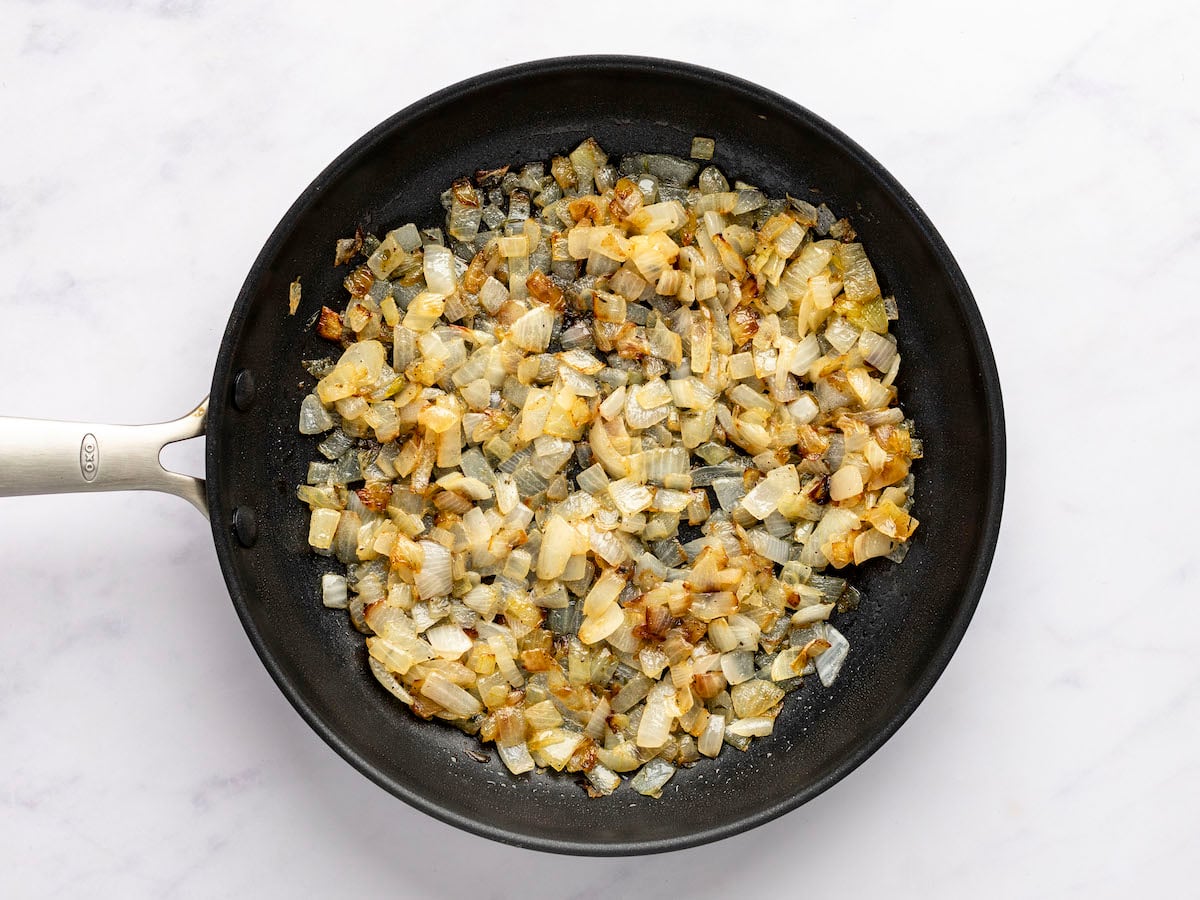 large skillet with cooked onion mixture