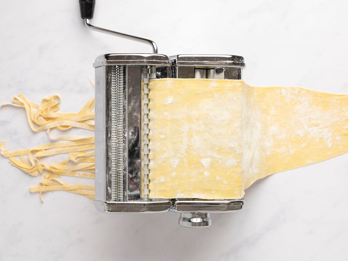 pasta coming out of pasta machine as long, wide noodles