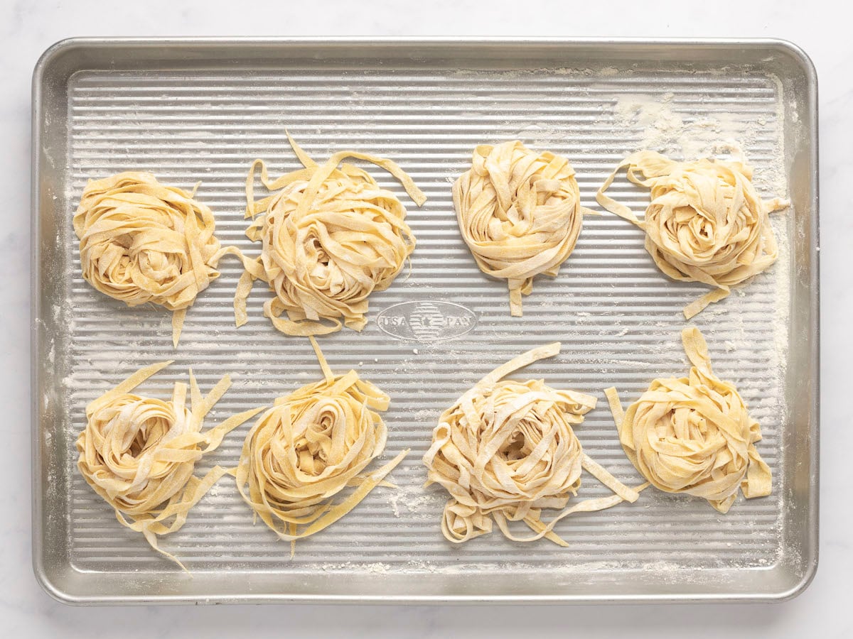 baking sheet with nests of flour-dusted cut noodles