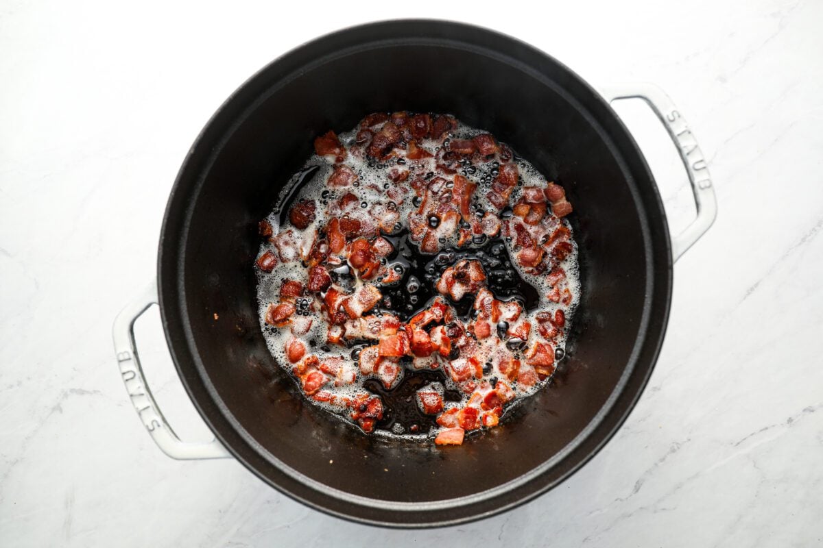 Diced bacon cooking in dutch oven