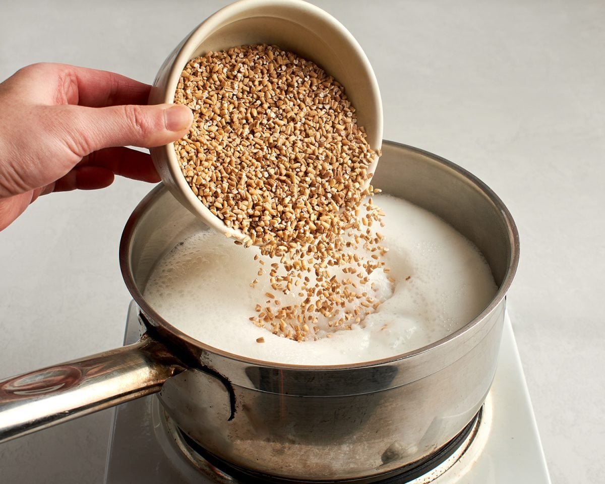 adding the steel cut oats to the simmering liquid