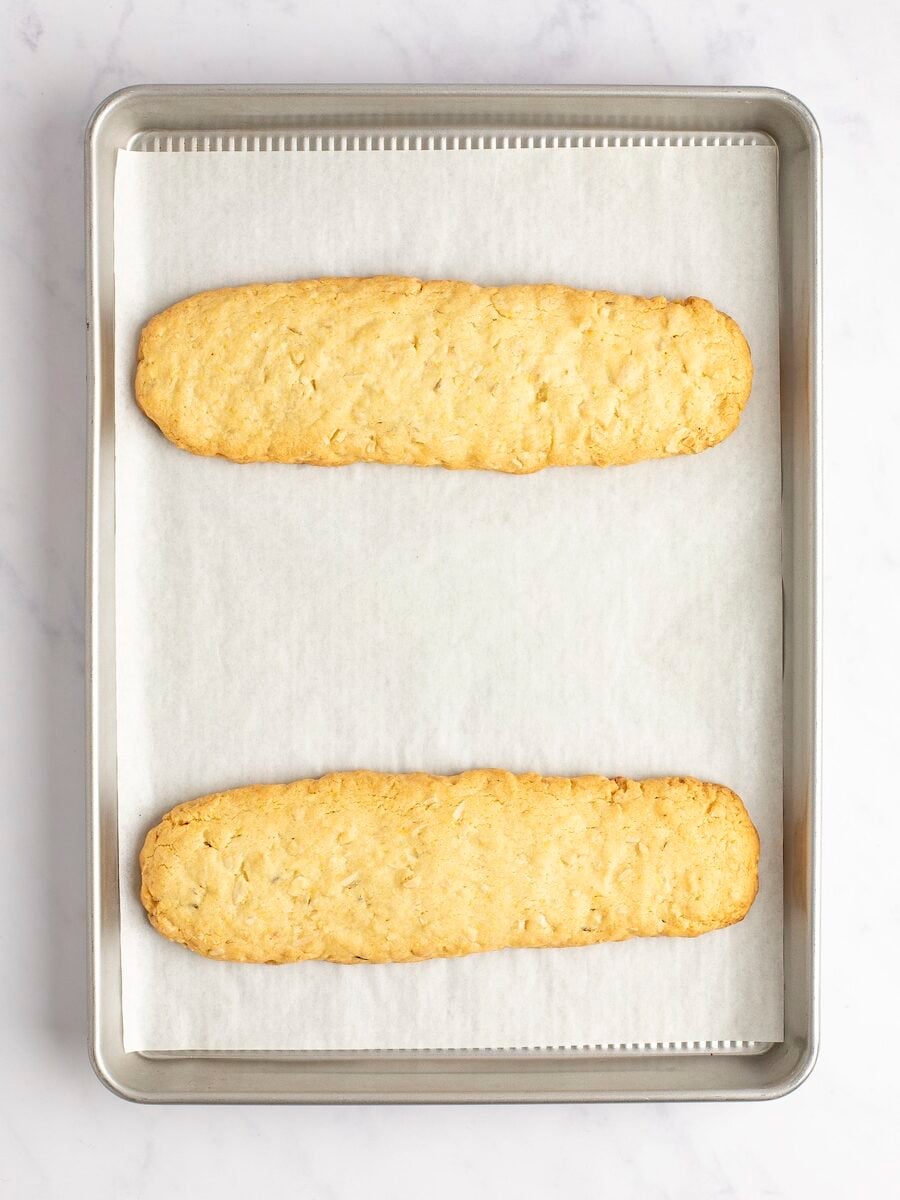 Baked biscotti logs on baking sheet.