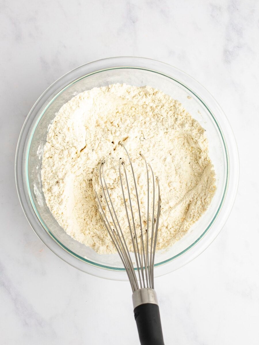 Mixed dry ingredients in bowl with whisk.