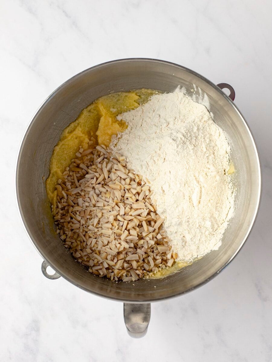 Adding dry ingredients and almonds to egg-butter-sugar mixture.