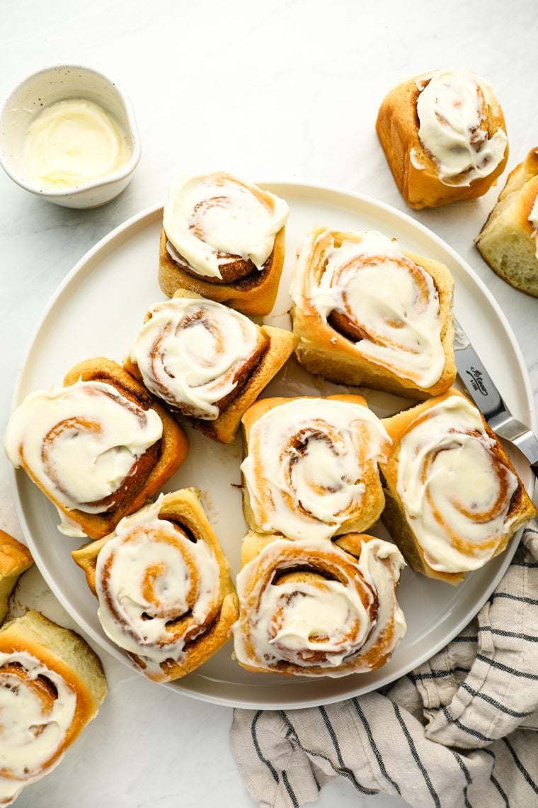 cinnamon rolls with cream cheese frosting on platter