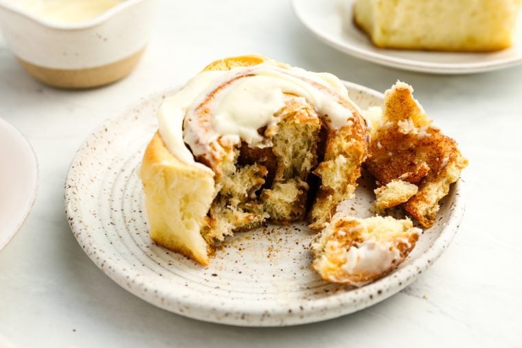 pulled apart cinnamon roll on white plate