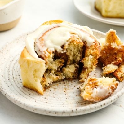pulled apart cinnamon roll on white plate