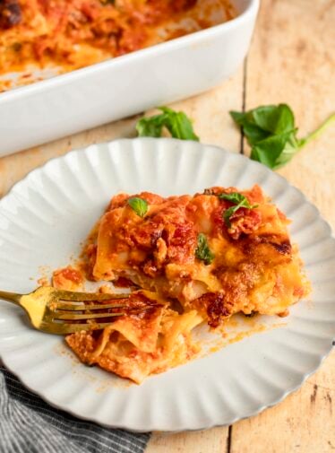 Slice of cheese lasagna on plate.