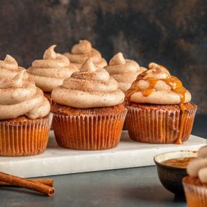 churro cupcakes on marble board with caramel sauce