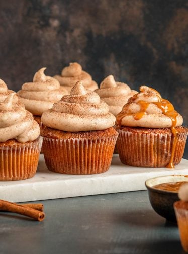 churro cupcakes on marble board with caramel sauce