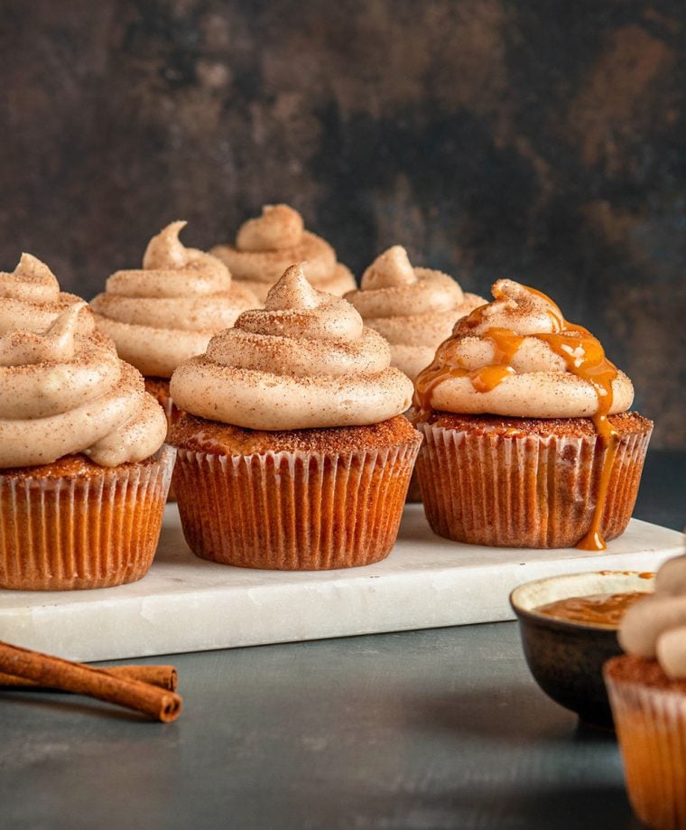 churro cupcakes on marble board with caramel sauce