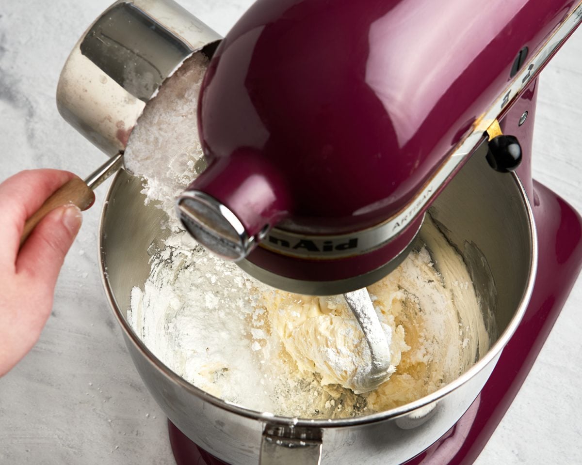 adding powdered sugar to creamed butter