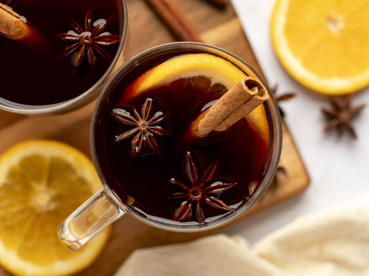 mulled wines in mugs with garnishes