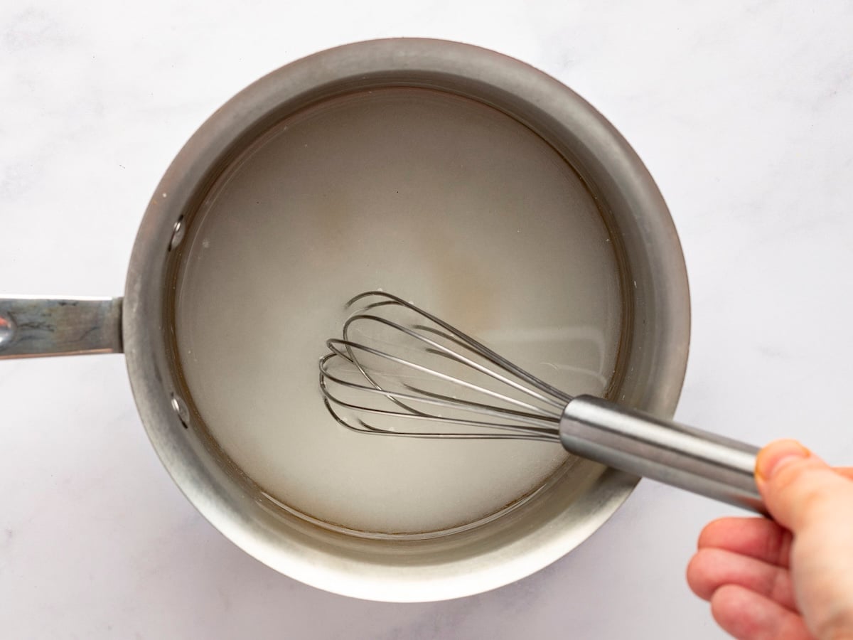 whisking sugar and water in saucepan.