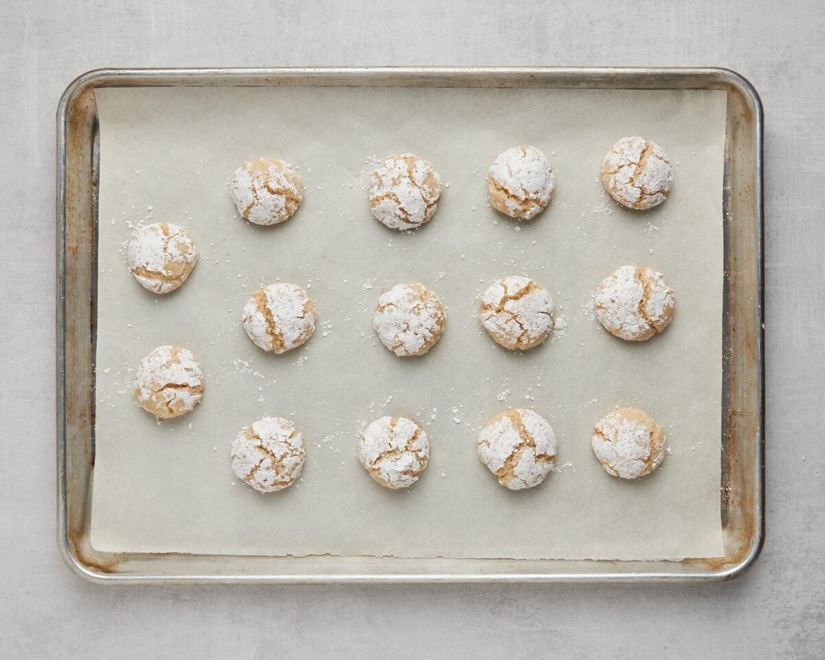 baked almond cookies on parchment-lined baking sheet