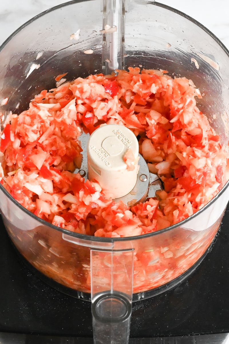 minced vegetables in bowl of food processor.