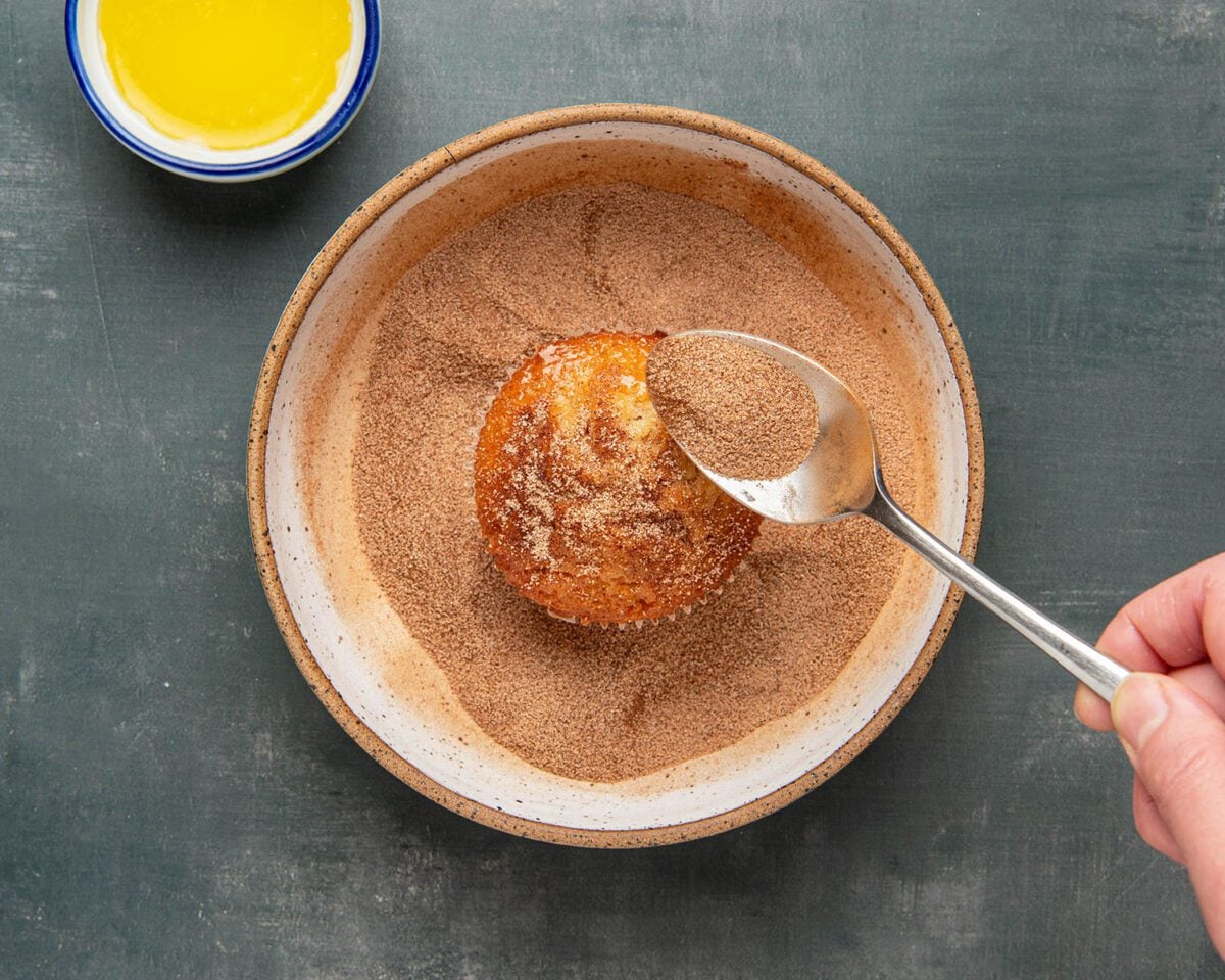 topping cupcakes with butter and cinnamon sugar mixture