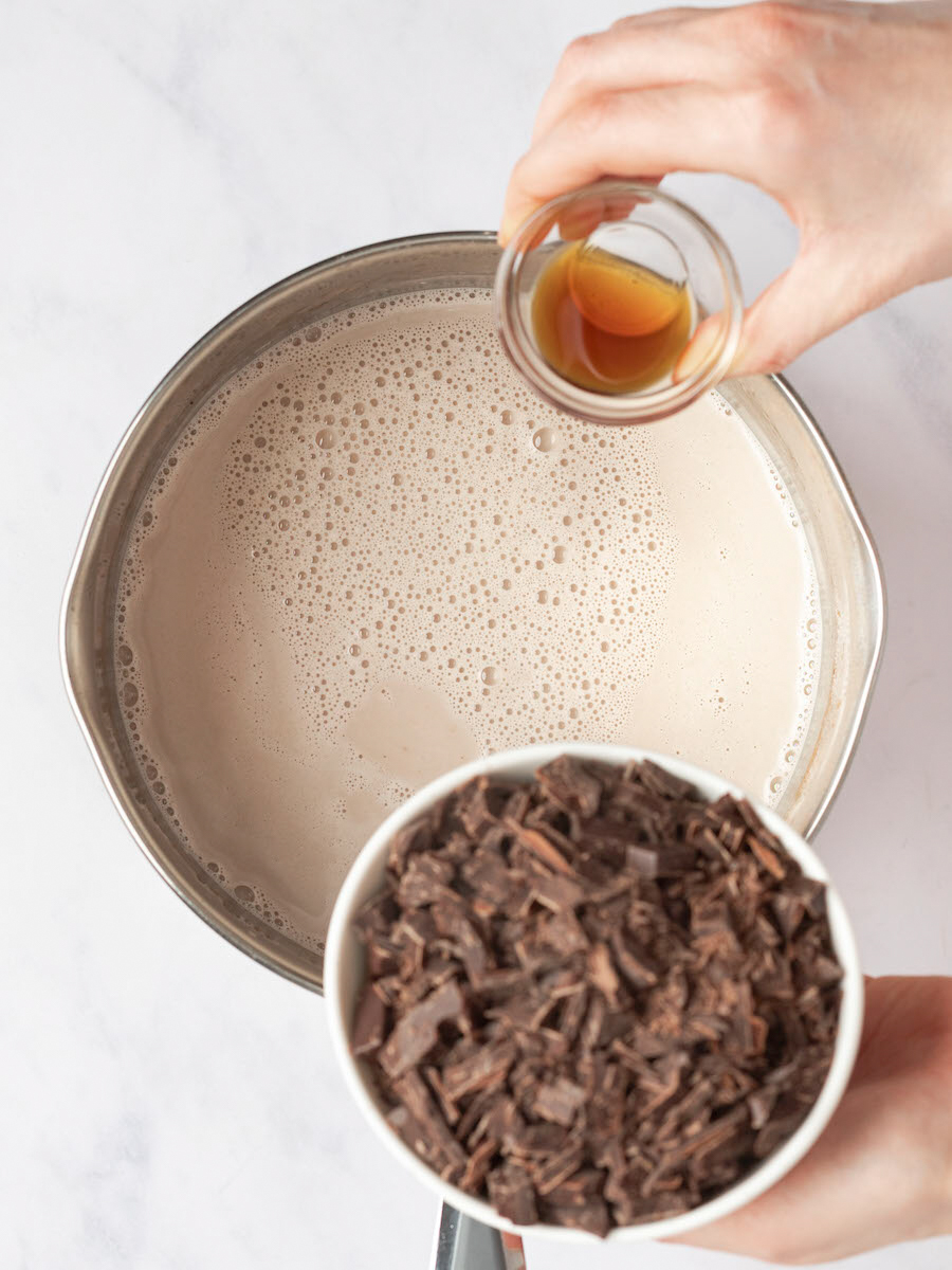 adding chocolate and vanilla to base mixture for hot chocolate.