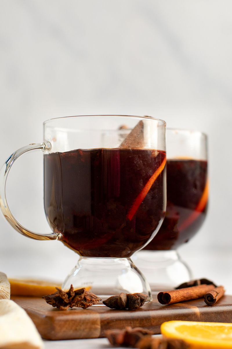 mulled wines in mugs with garnishes
