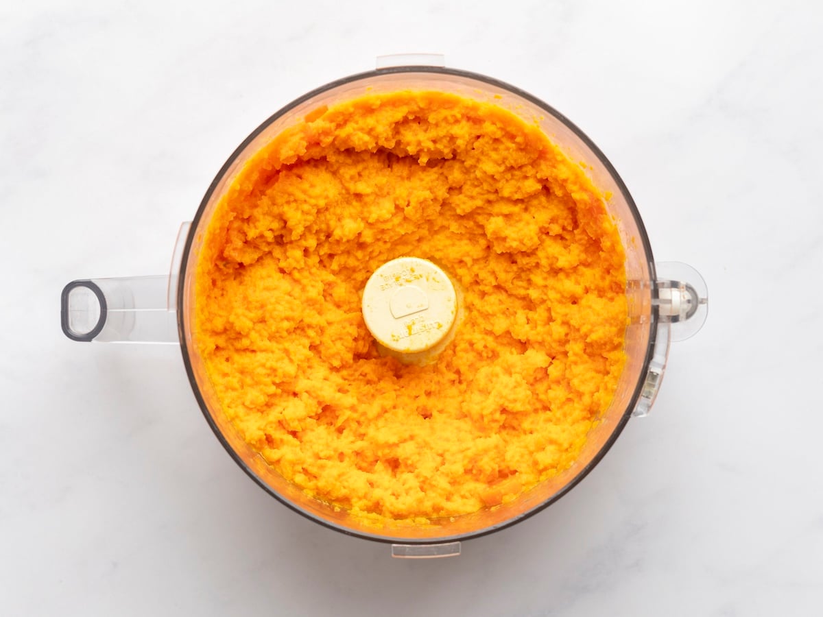 foood processor bowl with blended butter and carrots
