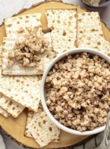 white bowl of charoset surrounded by pieces of matzo