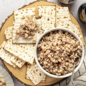 white bowl of charoset surrounded by pieces of matzo