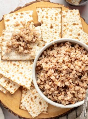 white bowl of charoset surrounded by pieces of matzo