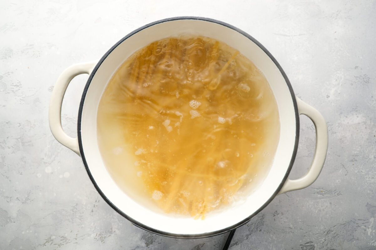 fettuccine cooking in salted water in Dutch oven