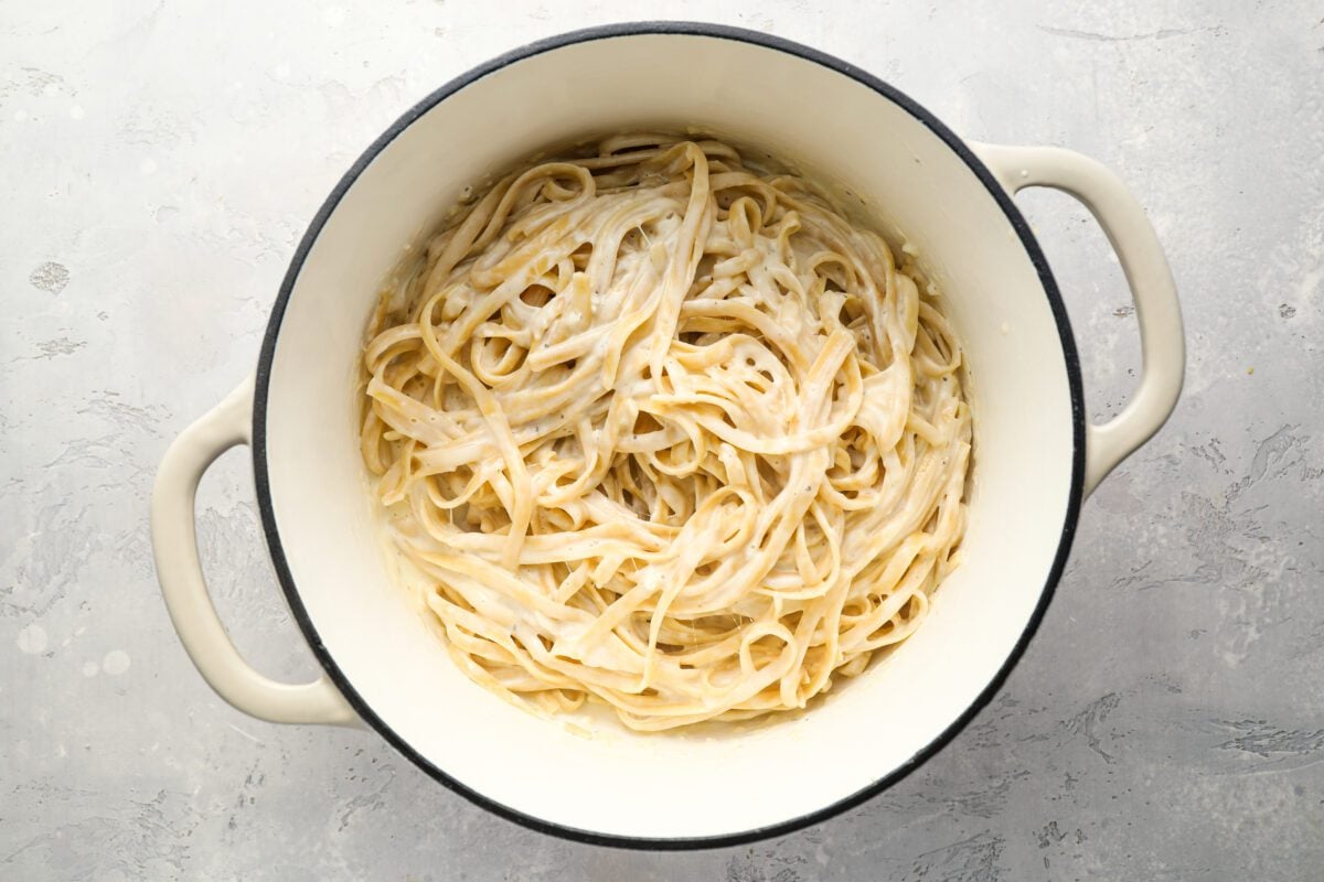 fettuccine tossed with cream sauce in Dutch oven