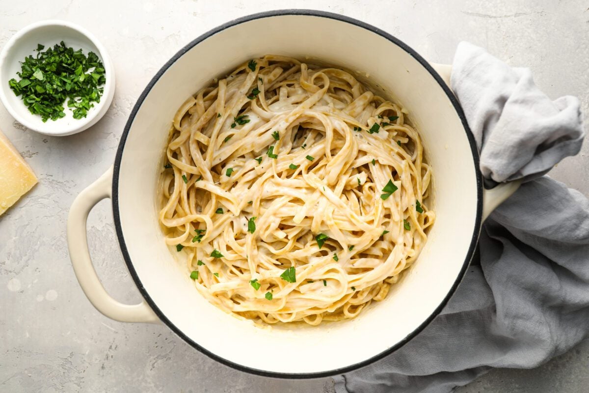 fettuccine alfredo in pot with linen napkin.
