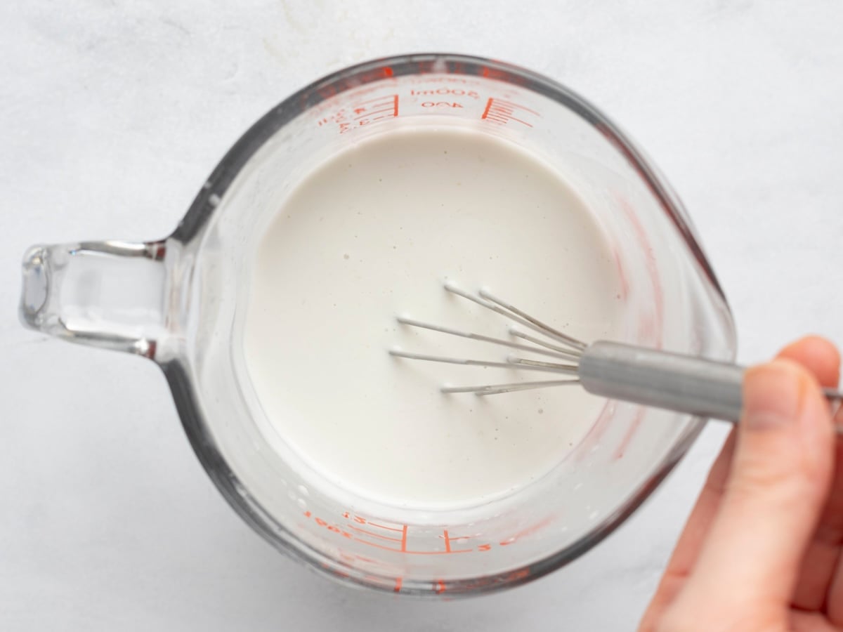 whisking coconut milk and lemon juice in