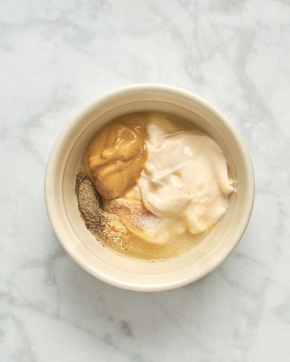 mayonnaise, mustard, lemon juice, salt, pepper, and garlic powder in medium bowl
