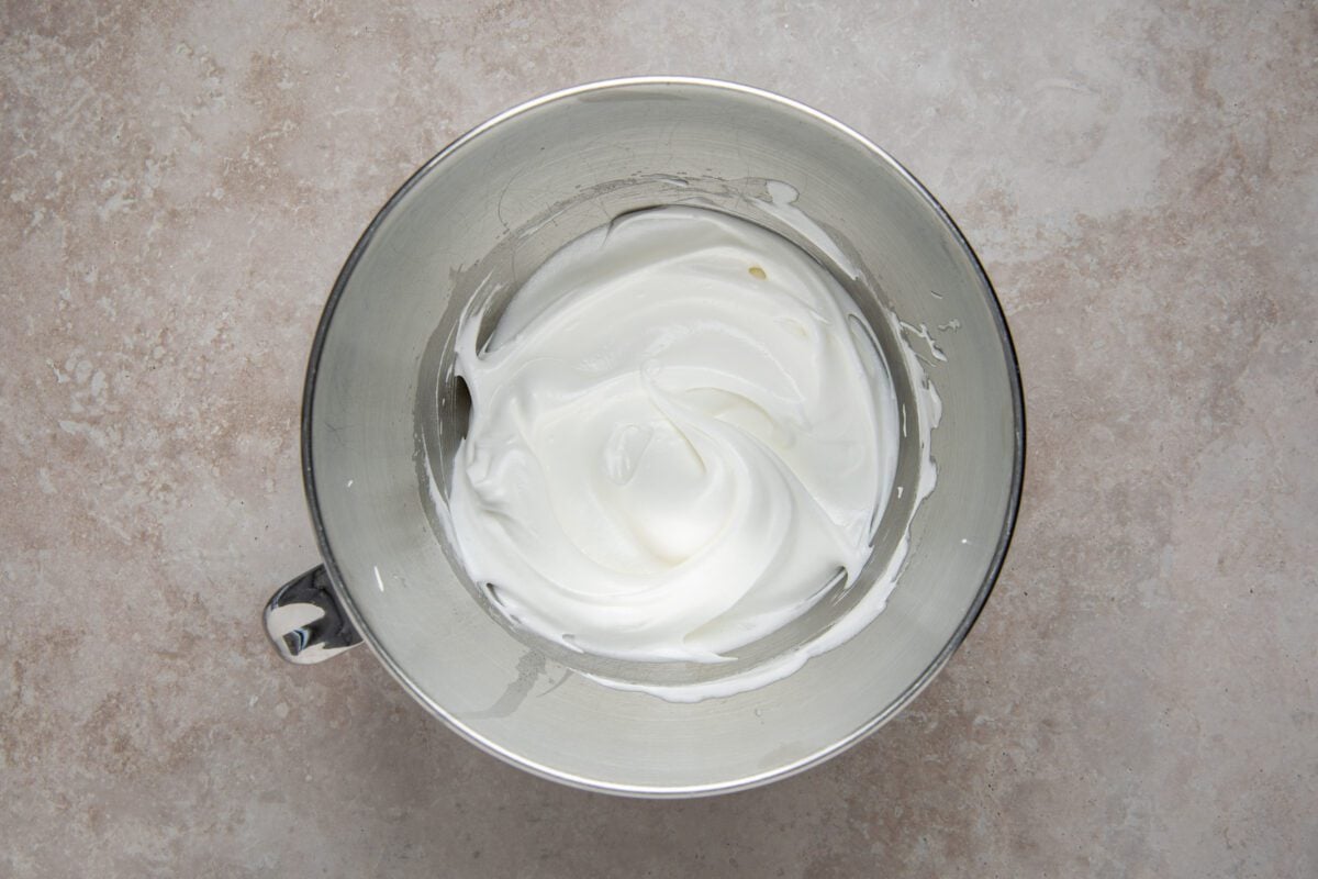 egg whites forming medium peaks in mixing bowl