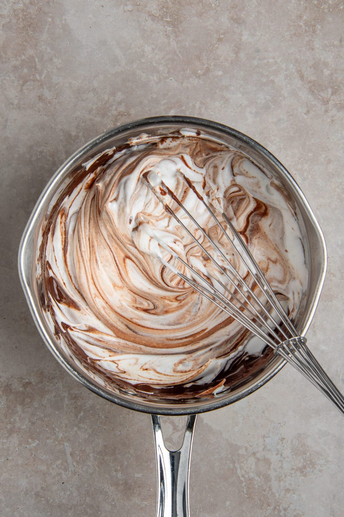 whisking 1/3 of egg white/sugar mixture to chocolate mixture