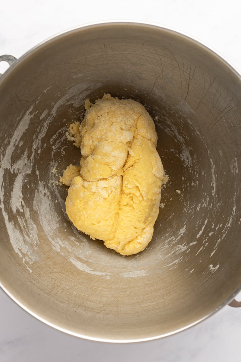 mixing bowl with flour, eggs, oil, and salt in cohesive mass.