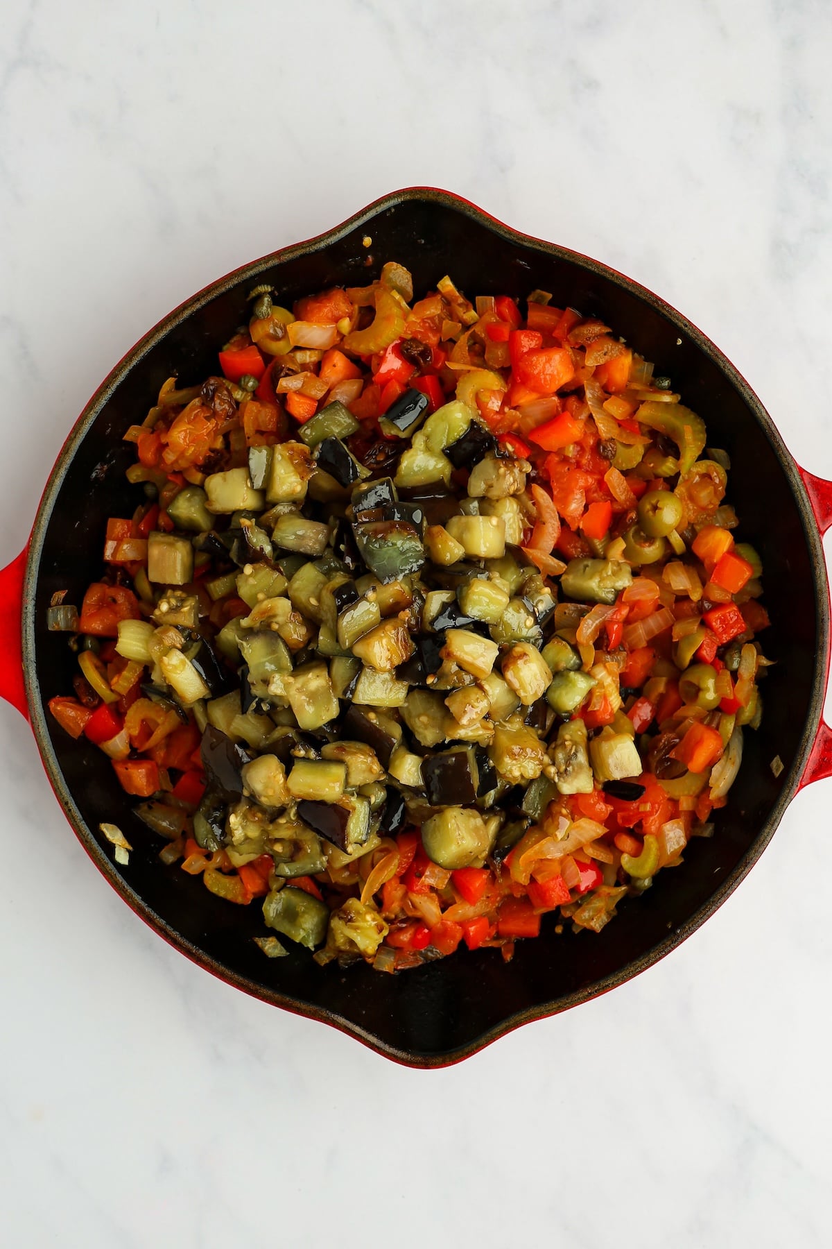 large skillet with cooked eggplant on top of cooked vegetable mixture