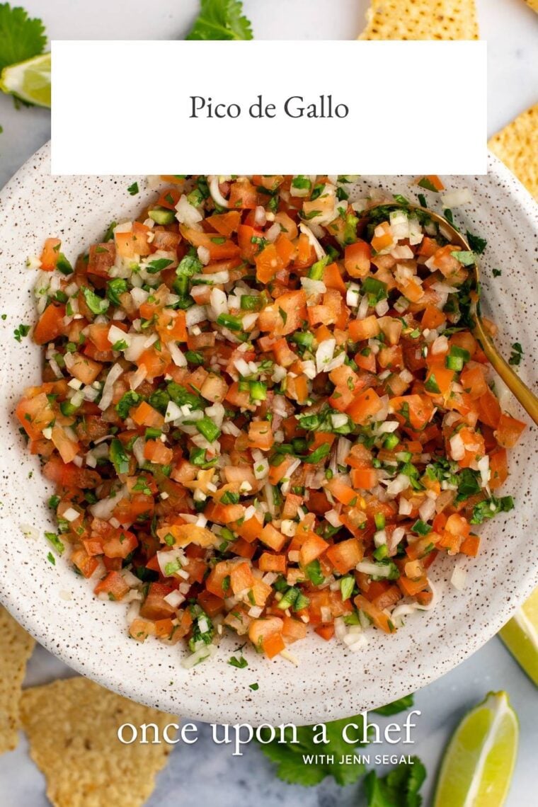 pico de gallo in white speckled bowl with tortilla chips nearby