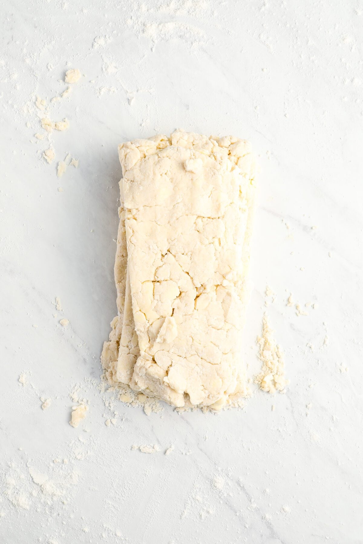 three rectangular pieces of dough stack on top of one another