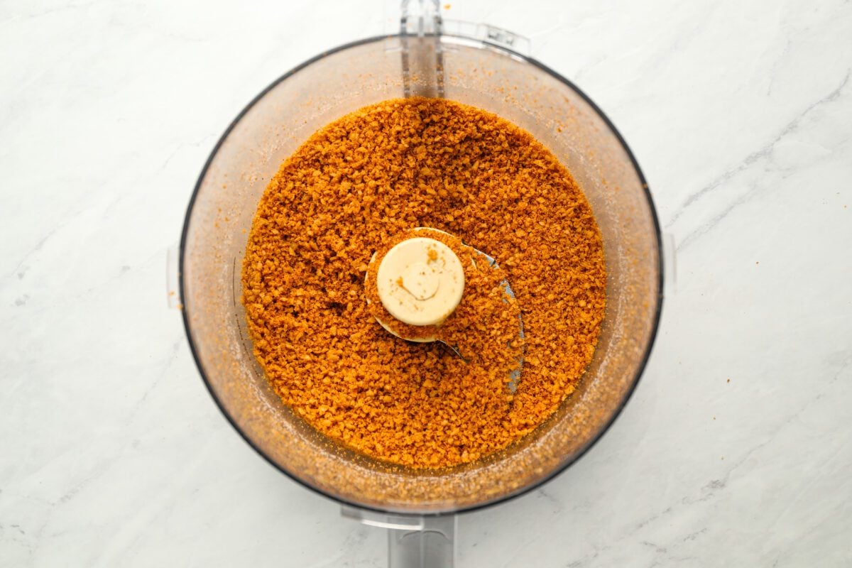ground tortillas and spices in bowl of food processor
